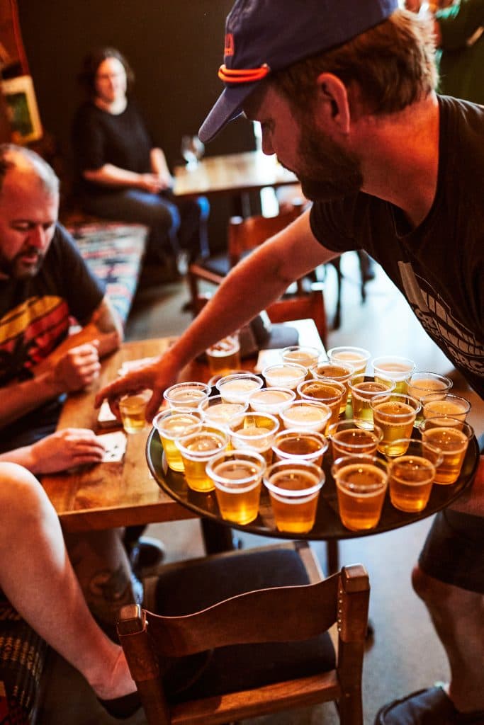 Freshly poured pints at Proper Pint Taproom in Woodstock neighborhood